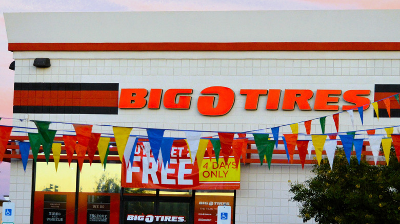 A Big O Tires warehouse shop with the neon logo prominently displayed above the entrance
