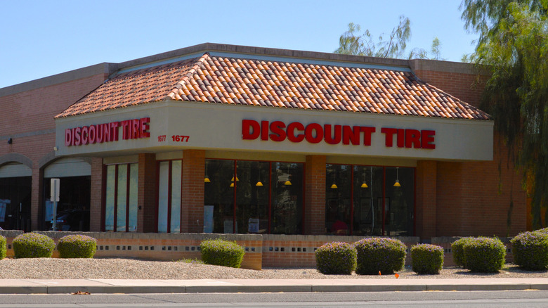 A discount tire store photographed from across the road, with an intersection in between