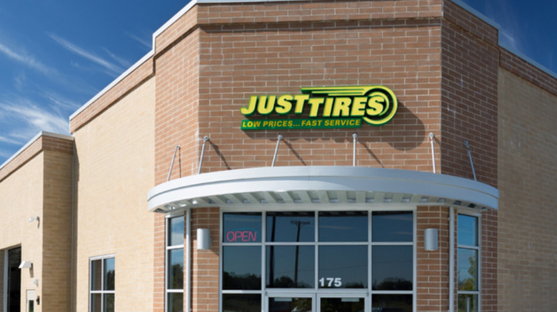 A Just Tires storefront, complete with iconic yellow and green sign up top