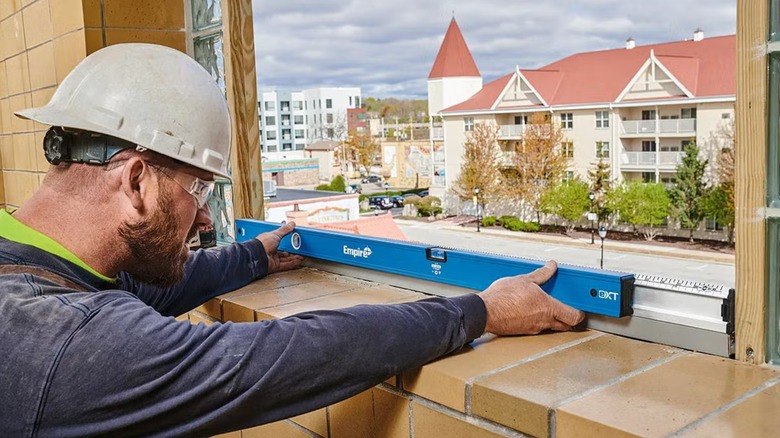 builder using an Empire level