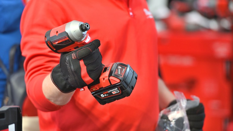 hand holding a red milwaukee power tool