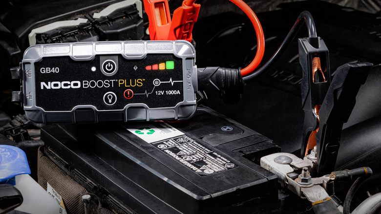 Noco battery jump starter attached to car battery.