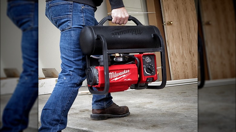 carrying Milwaukee compressor
