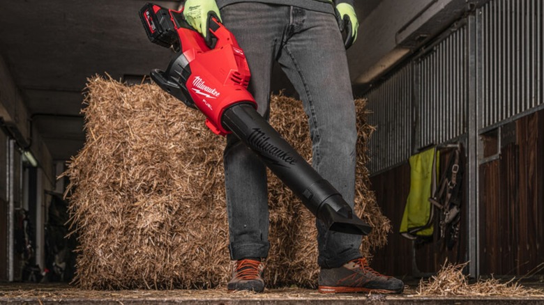 clearing hay with Milwaukee blower