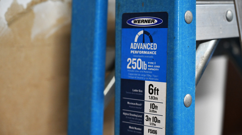 A Werner brand ladder with a sticker showing its specifications.