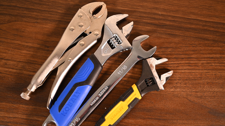 Four wrenches lined up on a table.