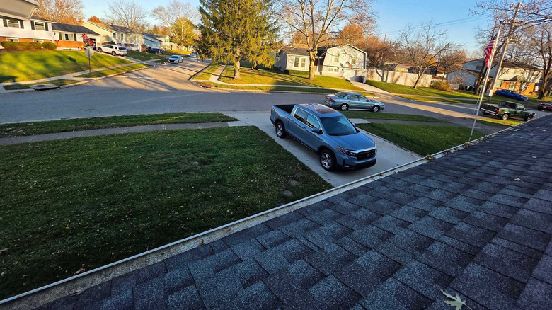 SlashGear writer Joe Hindy on his roof cleaning his gutters.