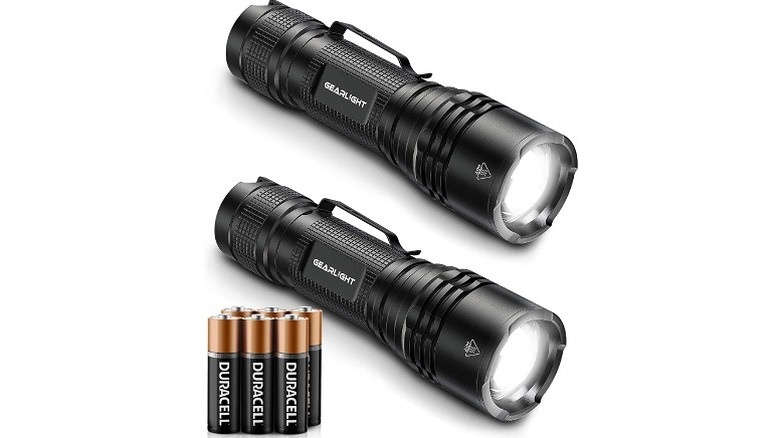 Two torches placed alongside batteries.