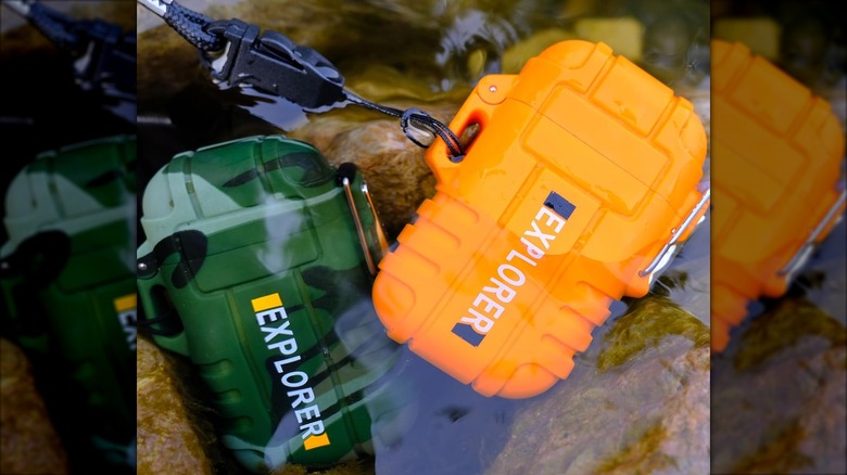 Two outdoor lighters, green and orange, placed together.