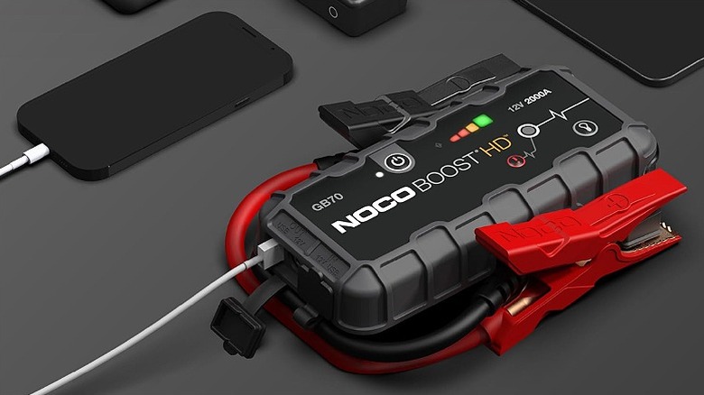 A jump starter charging a smartphone.