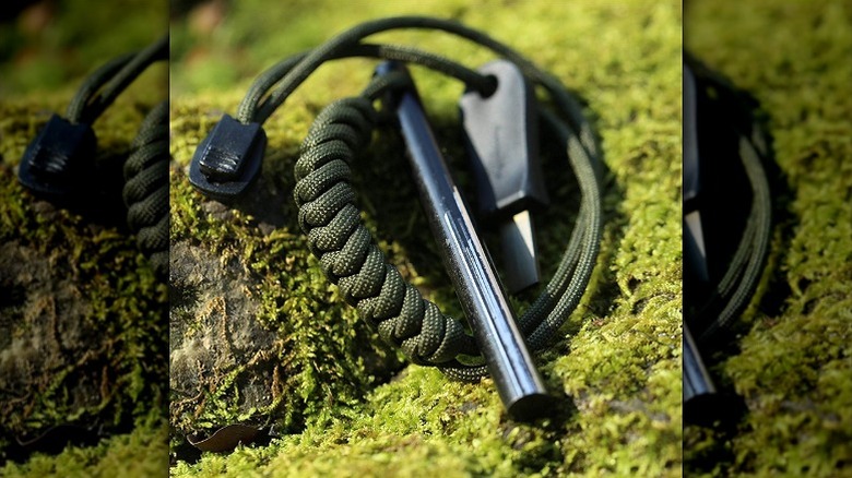 A fire starter and striker attached to a lanyard.