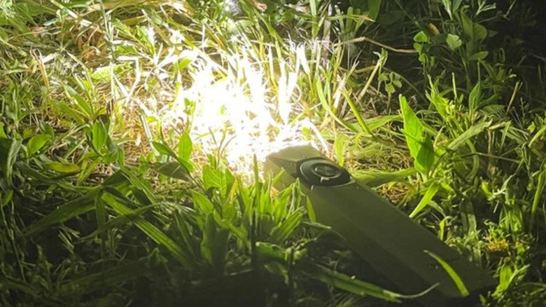 Olight Arkfield Ultra flashlight in grass