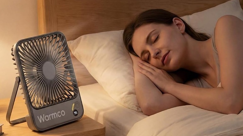 Person sleeping next to a Warmco D3 fan on a nightstand