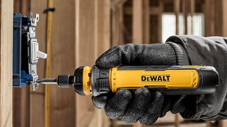 Using a DeWalt screwdriver to work on a fastener.