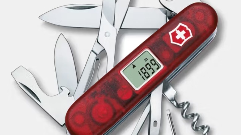 A red Victorinox Traveller Swiss Army Knife with a digital altimeter on the front of the scale.