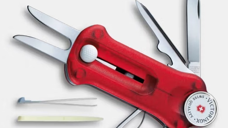 A close-up of a red Victorinox GolfTool, showing many tools including the divot repair forks.