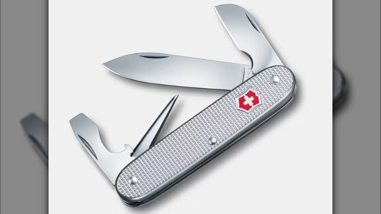 A silver Victorinox Electrician Swiss Army knife with a textured handle, red shield logo, and all the tools extended.