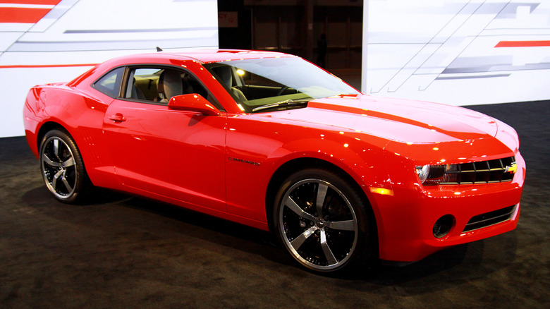 Red 2012 Camaro at auto show.