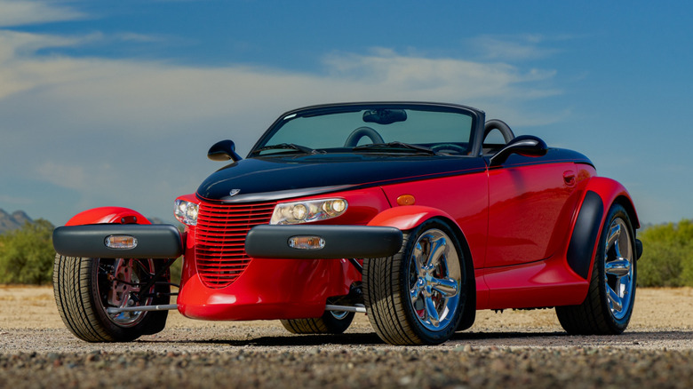 Red and black Plymouth Prowler on road.