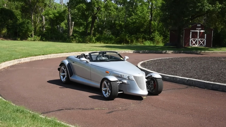 Silver Plymouth Prowler parked on road.