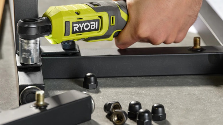 A person building a metal frame with the help of a USB Lithium ratchet