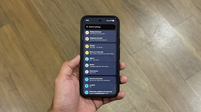 The main menu of a a Google Pixel phone, wooden floor in the background.
