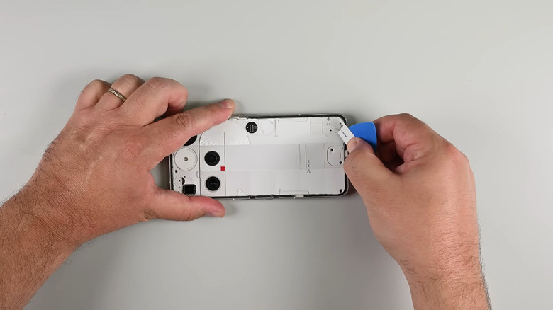 A pair of hands opening up the Nothing Phone 3