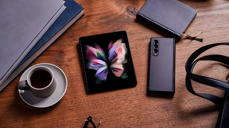 Samsung foldable on a desk with other items