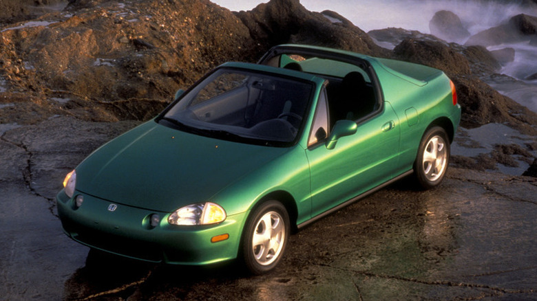 Green Honda Del Sol atop an ocean-swept cliff