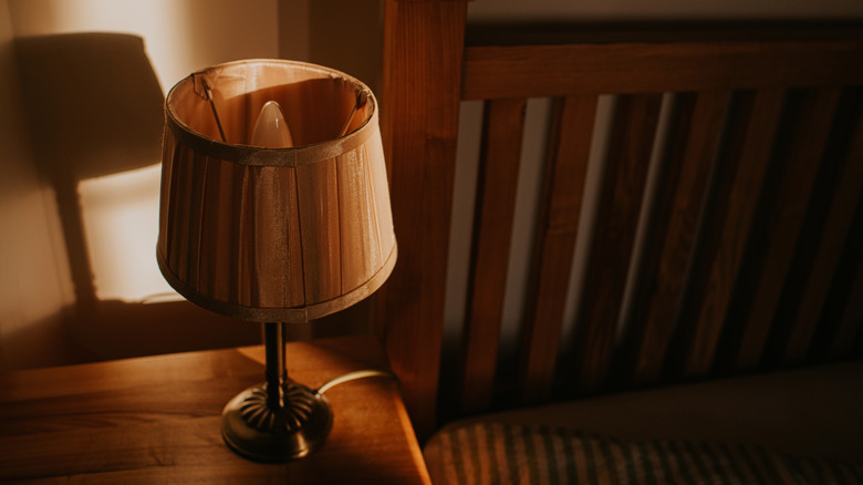 Lamp with a wooden cover