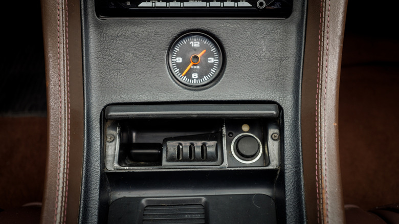 Car ashtray with an analog clock above it