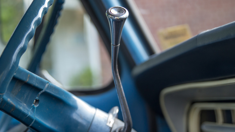 Close up of a column gear shifter and steering wheel