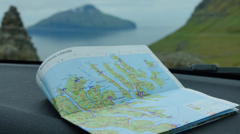 Close up of a road map with mountains in the background