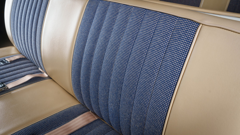 Close up of a tan car bench seat with blue textile accents