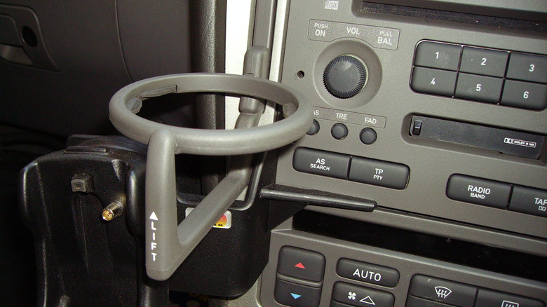 Close up of a pop-out cupholder in a car