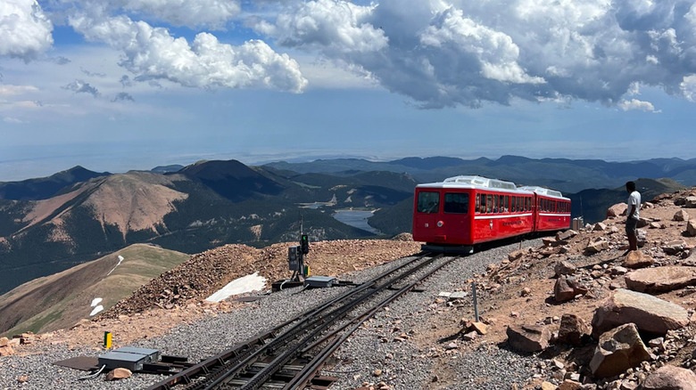 A photo of a train climbing a mountain