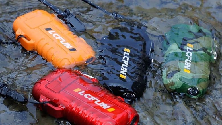 Many lcfun electric dual arc lighter cases floating in a river