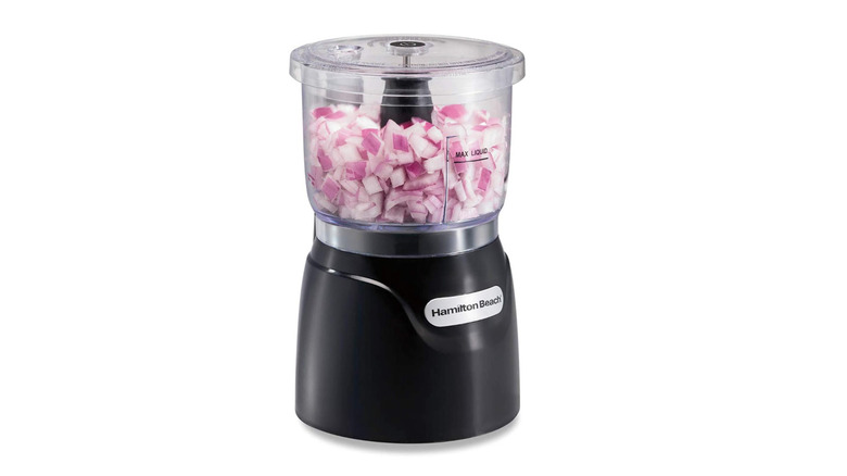 A Hamilton Beach Electric Vegetable Chopper & Food Processor chopping onions.