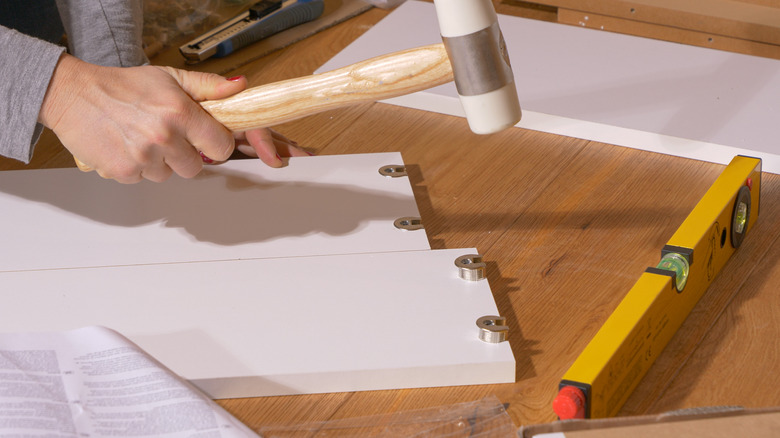 striking workpiece with a rubber mallet