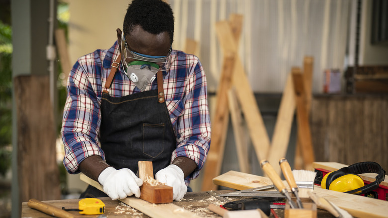 woodworker using traditional wooden plane