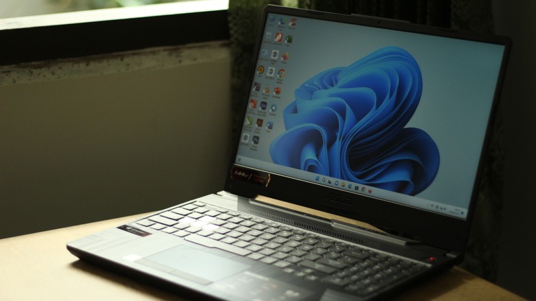An open laptop on a desk showing Windows 11's desktop