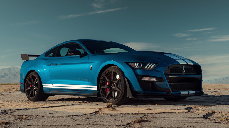 Ford Mustang Shelby GT500 parked on broken asphalt