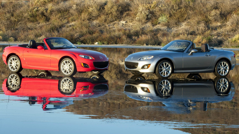 Two Mazda Miatas parked on water