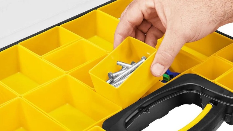 Person putting screws in Storehouse 20-Bin Case