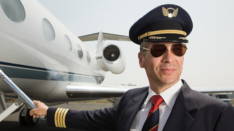 Pilot standing front of plane