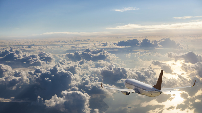 Plane flying above clouds
