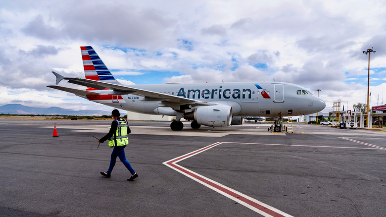 American Airlines plane on tarmac near airport official
