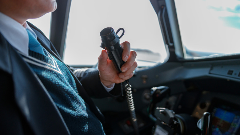 Pilot using radio in aircraft
