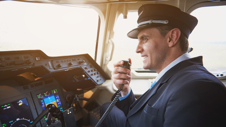 Pilot using radio in plane