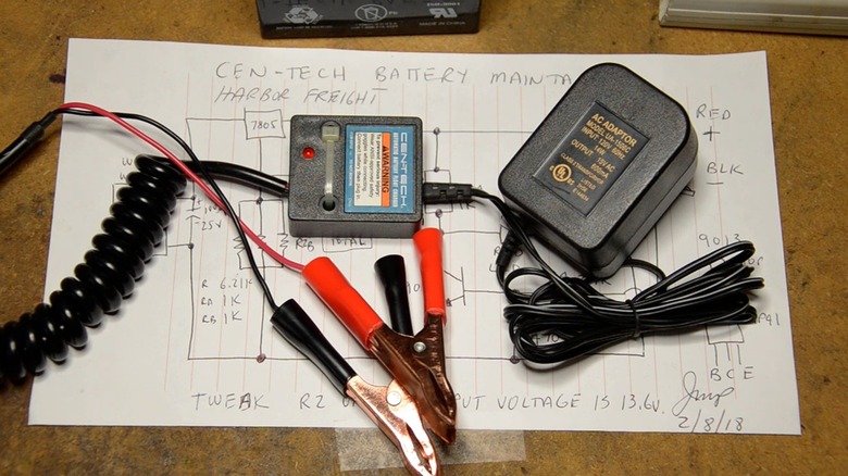Battery maintainer on table atop a hand-drawn circuit schematic